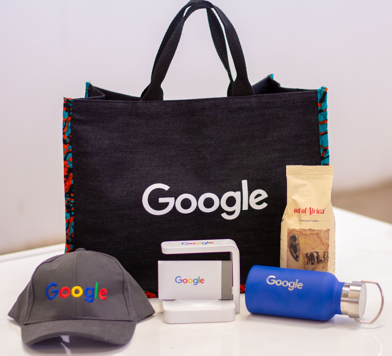 Branded corporate swag set — tote bag, cap, water bottle and stamp